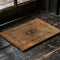 Rectangular coir doormat with central evil eye symbol surrounded by lunar phases, in natural tan with black designs.